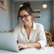 Young woman typing on a laptop in a stylish cafe setting