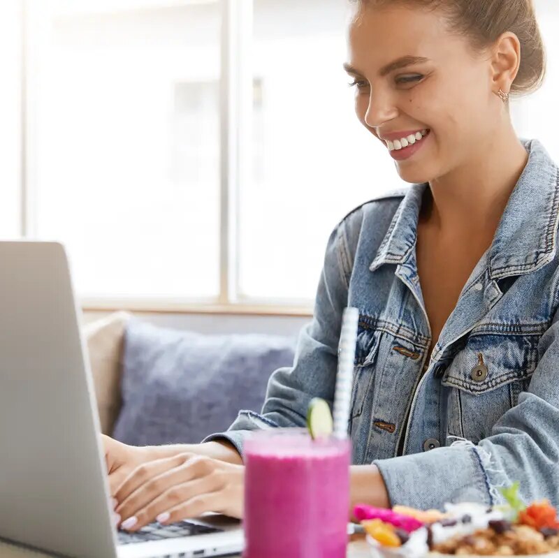 Woman in stylish denim jacket in coffee shop